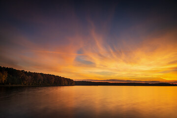 Fototapeta na wymiar beautiful sunrise over the lake. Autumn sunrise over the Zemborzycki Reservoir. Reflections in the water.