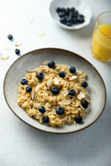 Homemade oatmeal porridge with blueberry and almond flakes