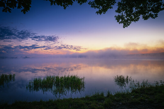 beautiful sunrise over the lake. Autumn sunrise over the Zemborzycki Reservoir. Reflections in the water. © RafalDlugosz