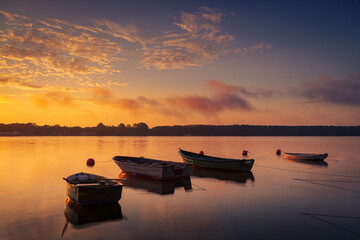 Boat on the lake in the rays of the rising sun and fog, zemborzycki lake © RafalDlugosz