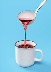 Mulled wine in a rustic enamel mug. Pouring hot red wine with the ladle