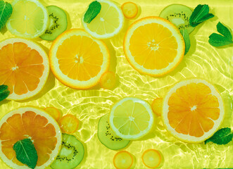 Fototapeta na wymiar Tropical fruit pattern of orange, lime and lemon slices, summer composition of fruits and vitamins, orange and green color of your fantasies
