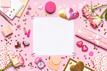 Fototapeta na wymiar Happy Valentine's day. Roses flowers, hearts, gifts and decorative items in pink pastel colors on pink background. Blank empty white paper sheet. Valentines day concept. Flat lay, top view, copy space