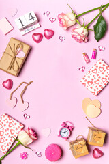 Happy Valentine's day. Frame made of roses flowers, hearts, gifts and decorative items in pink pastel colors on pink background. Greeting card for Valentine's day. Flat lay, top view, copy space