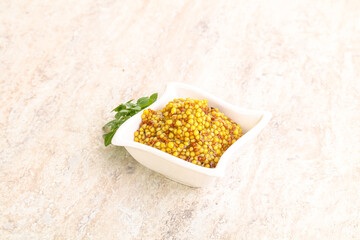 Grain mustard sauce in the bowl