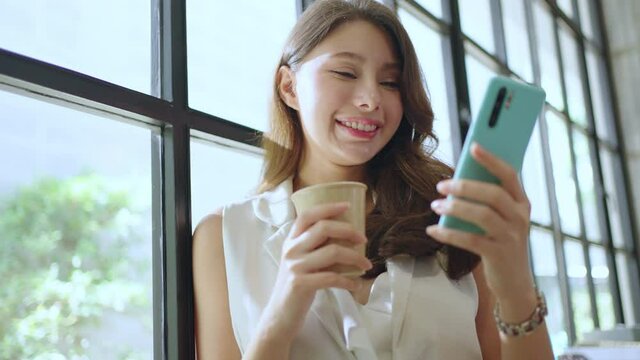 asian Female enjoy call,online chat,internet purchase, browse web, download new freeware application.Asian woman hands typing message on smart phone in application for business correspondence.