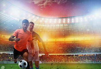 Obraz na płótnie Canvas Soccer players play with soccerbal at the stadium
