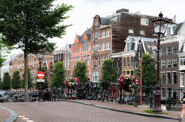 street view with buildings, greenery, sky and canals