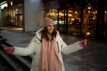 Caucasian white girl with sparklers Christmas shopping. High quality photo