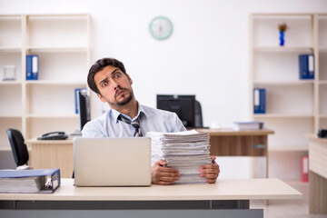 Young male employee working in the office