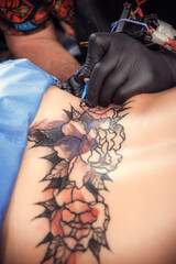 Skin master working on professional tattoo machine device in salon