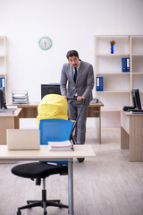 Young male employee looking after new born at workplace