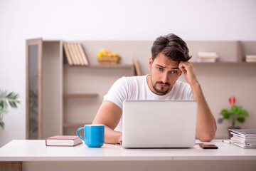 Young male employee working from home during pandemic