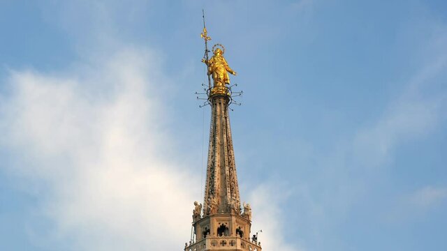 Europe , Italy , Milan December 2021 - 
the Madonnina of Duomo with its typical spiers, aerial view of the city skyline  at sunset