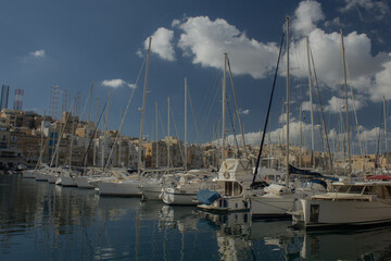 Fototapeta na wymiar Bay with marina and boats during clear day on island of Malta