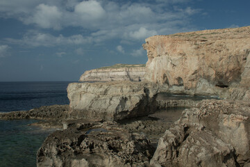 Fototapeta na wymiar Coast with water and sky in late day on island of Malta, Gozo