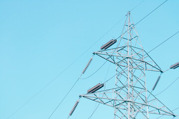Electricity pylon, high voltage transmission tower on blue sky..