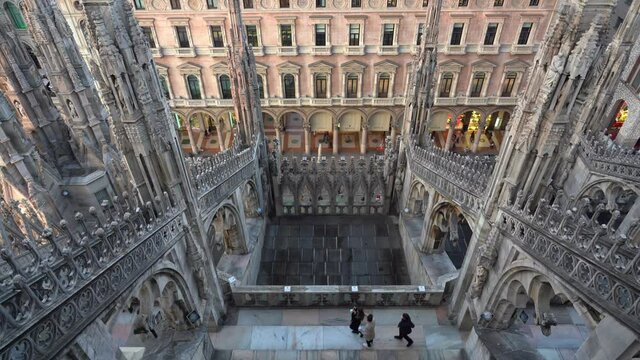 Europe , Italy , Milan December 2021 - 
the Madonnina of Duomo with its typical spiers, aerial view of the city skyline  at sunset