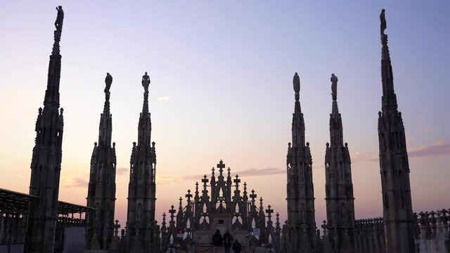 Europe , Italy , Milan December 2021 - 
the Madonnina of Duomo with its typical spiers, aerial view of the city skyline  at sunset