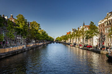 Fototapeta premium Street view with buildings and during day and canal in Amsterdam, Netherlands