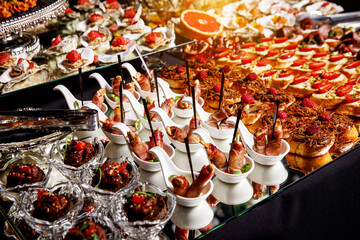 Banquet Meat Bar. Cold snacks with vegetables, fish and rucola on bread, canapes