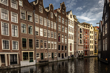 Fototapeta na wymiar Street view with buildings and during day and canal in Amsterdam, Netherlands