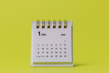 Desktop calendar for January 2022 on a yellow background.