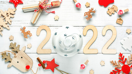 Wooden 2022 numbers on White background. Creative concept of Xmas and New Year