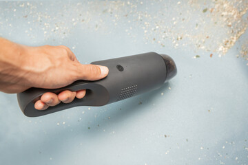 Wireless portable handheld vacuum cleaner with high suction power. Removes construction debris and dust © EdNurg