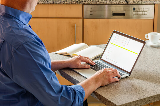 Gesch&auml;ftsmann arbeitet im Homeoffice am Laptop