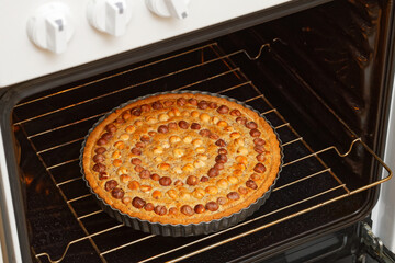 Closeup homemade pie with nuts hazelnut baked in a home oven. Shallow focus.