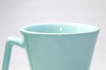 Ocean green coffee cup with white background.