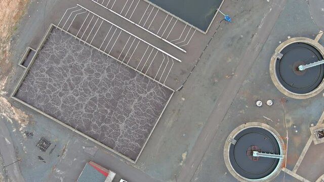 Aerial top view of sewage water treatment plant facilities recirculation sedimentation tank