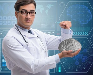 Male doctor with the brain in medical concept