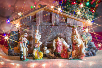 Christmas nativity scene. Hut with baby Jesus in the manger, with Mary, Joseph and the three wise...