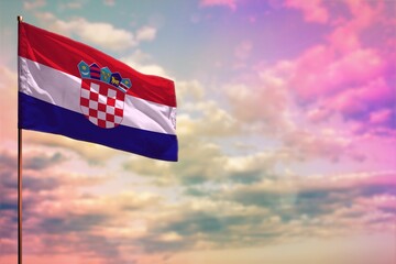 Fluttering Croatia flag mockup with the space for your content on colorful cloudy sky background.