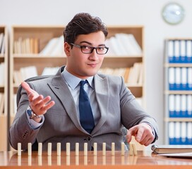 Businessman with dominoes in the office
