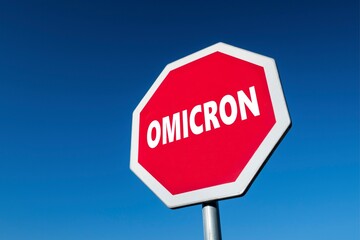 Trafffic sign with text OMICRON to stop the spread of corona virus