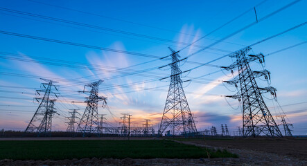 In the evening, the silhouette of high voltage towers