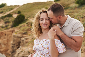 tender loving couple on a sunny summer day. a man gently touches his beloved cheek with his nose