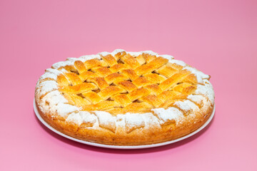 Tradition american Christmas apple pie with sugar crust on pink background