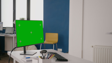 Company worker using green screen on computer at desk. Woman working with isolated mock up template...