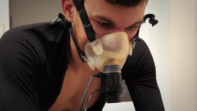 Cyclist athlete going through Vo2 Max testing on bicycle in modern sport science lab