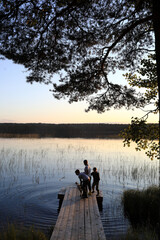 Three boys playing by lake