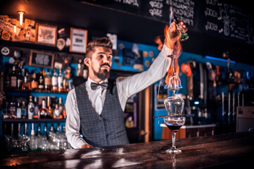 Barman makes a cocktail at the brasserie