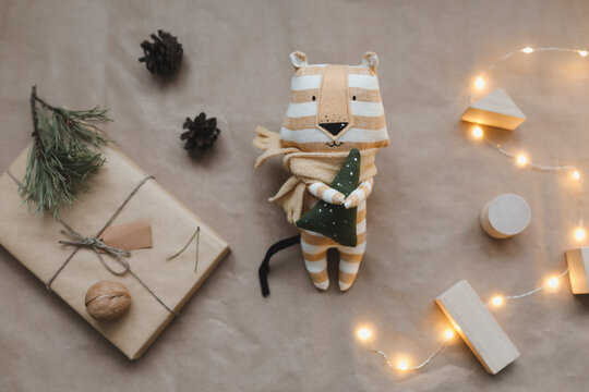 Christmas composition with a tiger toy, symbol of new 2022, a gift, fir tree branches and decorations. Christmas, winter, new year concept. Flat lay, top view