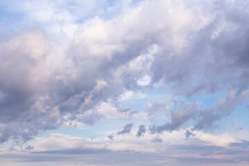 Beautiful epic blue sky with white and grey fluffy cumulus clouds in sunlight background texture	