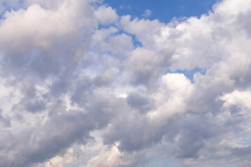 Fototapeta na wymiar Blue sky with beautiful white fluffy cumulus clouds in sunlight background texture 