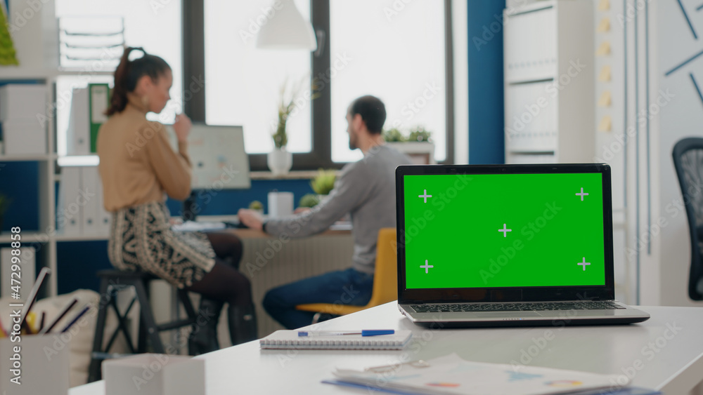 Poster close up of green screen on computer display in startup office. laptop with mock up template and iso