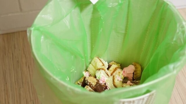 Throwing Cake in the trash bin. Start diet concept, weight loss and refusal